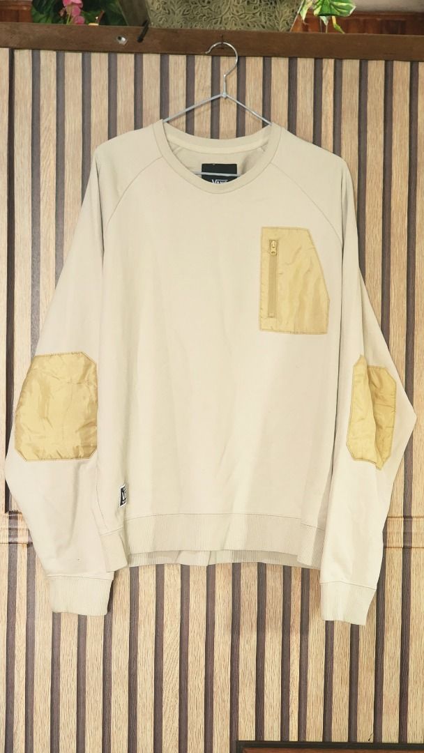 Vans Off The Wall Cream Sweatshirt Medium (Category: Coats, Jackets and Outerwear) located in Baguio. Submitted by genesisomega (Listing ID 1466278384, Image 1). Description: - Brand: Vans - Style: Crewneck sweatshirt with chest zipper pocket and contrasting elbow patches - Color: Cream - Size: Medium - Material: 70% cotton, 30% polyester (Made in China) - Details: Woven patch logo on lower hem .