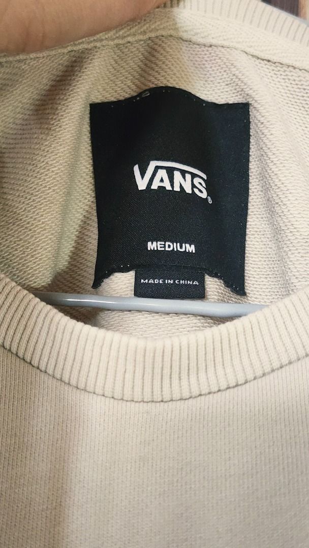 Vans Off The Wall Cream Sweatshirt Medium (Category: Coats, Jackets and Outerwear) located in Baguio. Submitted by genesisomega (Listing ID 1466278384, Image 3). Description: - Brand: Vans - Style: Crewneck sweatshirt with chest zipper pocket and contrasting elbow patches - Color: Cream - Size: Medium - Material: 70% cotton, 30% polyester (Made in China) - Details: Woven patch logo on lower hem .