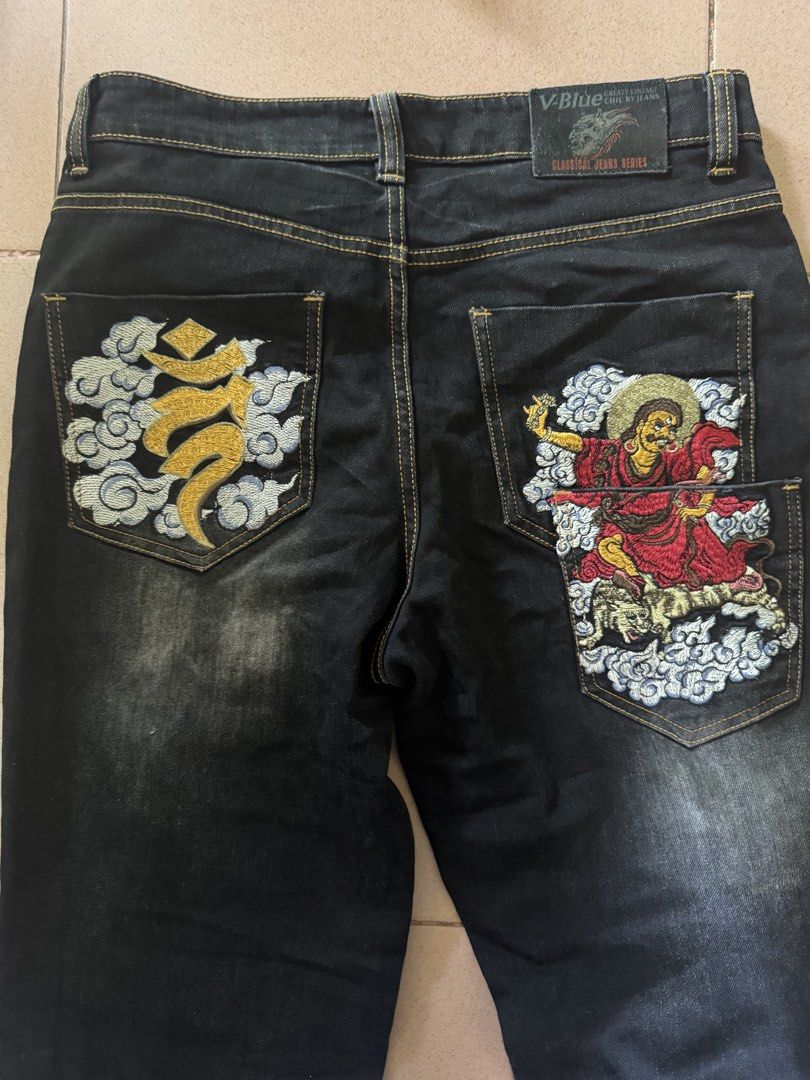 v.blue Classical Jeans Series Embroidered Dark Denim (Category: Jeans) located in Abuyog. Submitted by dreinab_19 (Listing ID 1466176177, Image 1). Description: - Brand/Series: V.Blue Classical Jeans Series - Wash: Dark wash denim with slight factory fading on front thighs - Design: Eye-catching colorful Asian deity embroidery and cloud motifs on back pockets - Details: Golden contrast stitching, front button and zipper closure, branded leather b