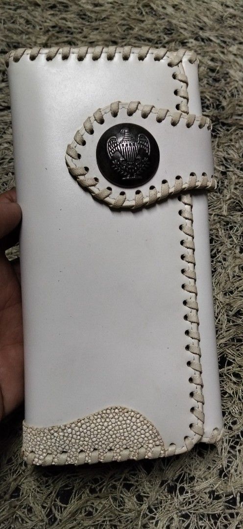 VenDome Long Wallet White Leather Whipstitch (Category: Wallets & Card holders) located in Paranaque City. Submitted by michael-08 (Listing ID 1466189193, Image 1). Description: - Brand: VenDome - Material: Genuine white leather with a textured bottom panel - Design: Contrast whipstitching and eagle emblem snap button - Interior: Tan leather lining - Storage: Multiple card slots, receipt pockets, clear ID slots, and zippered coin compartment - Co