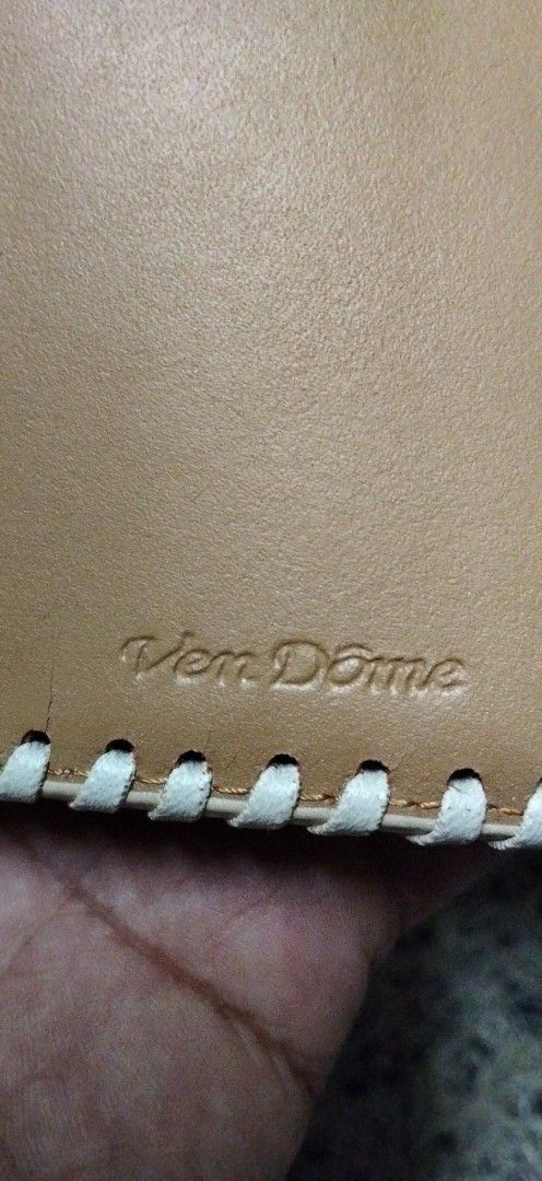 VenDome Long Wallet White Leather Whipstitch (Category: Wallets & Card holders) located in Paranaque City. Submitted by michael-08 (Listing ID 1466189193, Image 2). Description: - Brand: VenDome - Material: Genuine white leather with a textured bottom panel - Design: Contrast whipstitching and eagle emblem snap button - Interior: Tan leather lining - Storage: Multiple card slots, receipt pockets, clear ID slots, and zippered coin compartment - Co