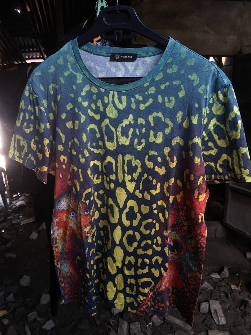 Versace Leopard Print Graphic T-Shirt Size M (Category: Tshirts & Polo Shirts ) located in San Fernando. Submitted by thrifteezy6 (Listing ID 1466203825, Image 1). Description: - Brand: Versace - Design: Bold multicolor leopard animal print (blue, green, yellow, red) - Size: Medium (regular fit) - Details: Crew neck, short sleeves, Made in Italy label - Mode of Payment: GCash or BDO accepted - Shipping: Fast shipping via J&T Express or LBC.