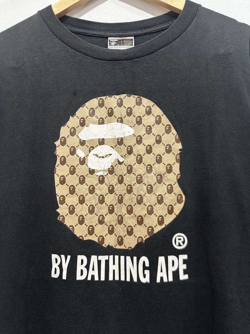 Vintage BAPE Big Ape Head Tee Monogram Design (Authentic) (Category: Tshirts & Polo Shirts ) located in Manila. Submitted by ylsrarities (Listing ID 1466332484, Image 2). Description: Pre owned with noticeable signs of age and wear. The graphic has significant cracking and aging throughout, particularly on the brown Ape Head print. The black body also shows general fading and fabric wear, with a small visible flaw/spot on the body as shown in the