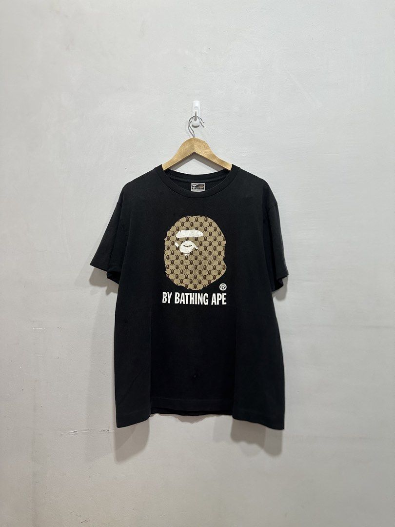 Vintage BAPE Big Ape Head Tee Monogram Design (Authentic) (Category: Tshirts & Polo Shirts ) located in Manila. Submitted by ylsrarities (Listing ID 1466332484, Image 1). Description: Pre owned with noticeable signs of age and wear. The graphic has significant cracking and aging throughout, particularly on the brown Ape Head print. The black body also shows general fading and fabric wear, with a small visible flaw/spot on the body as shown in the