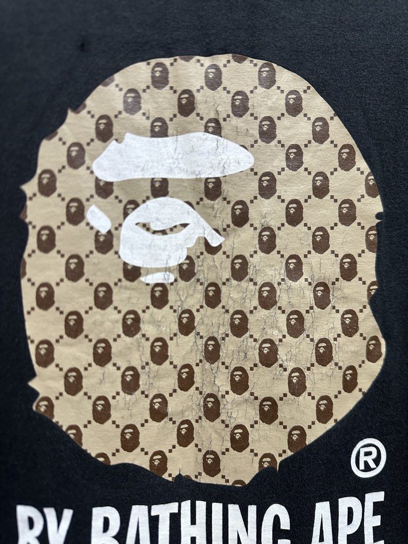 Vintage BAPE Big Ape Head Tee Monogram Design (Authentic) (Category: Tshirts & Polo Shirts ) located in Manila. Submitted by ylsrarities (Listing ID 1466332484, Image 3). Description: Pre owned with noticeable signs of age and wear. The graphic has significant cracking and aging throughout, particularly on the brown Ape Head print. The black body also shows general fading and fabric wear, with a small visible flaw/spot on the body as shown in the