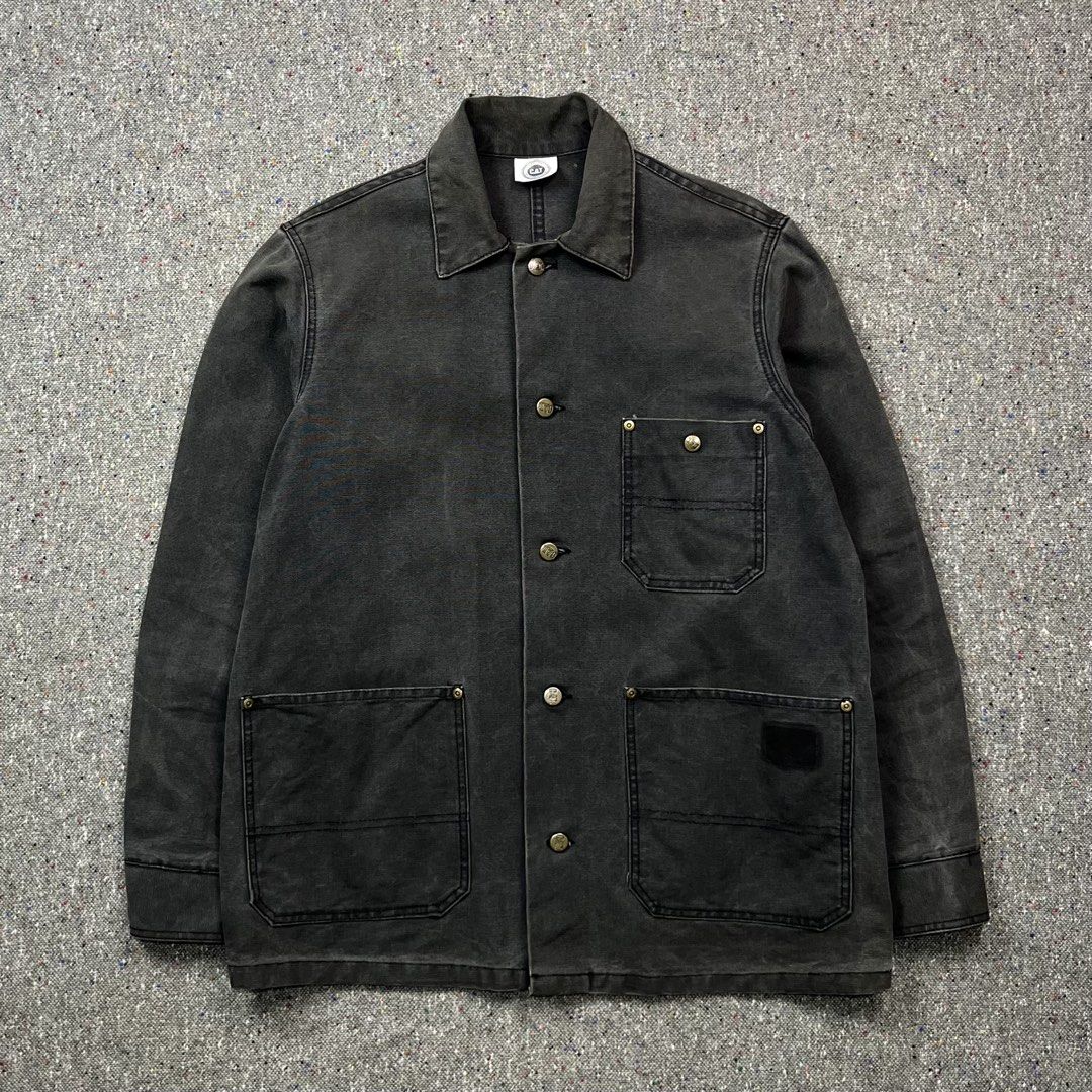 Vintage Caterpillar (CAT) washed black canvas chore jacket (Category: Activewear) located in Zamboanga. Submitted by deconstrukt.fit (Listing ID 1466329058, Image 1). Description: Caterpillar—primarily known as a heavy machinery manufacturer—has a long-running, highly durable work apparel line that has become a staple in vintage streetwear and heritage workwear subcultures. The jacket is made from a heavy-duty, tightly woven cotton duck canvas th