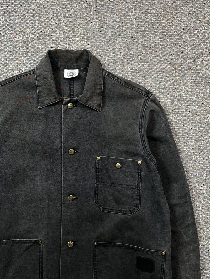 Vintage Caterpillar (CAT) washed black canvas chore jacket (Category: Activewear) located in Zamboanga. Submitted by deconstrukt.fit (Listing ID 1466329058, Image 2). Description: Caterpillar—primarily known as a heavy machinery manufacturer—has a long-running, highly durable work apparel line that has become a staple in vintage streetwear and heritage workwear subcultures. The jacket is made from a heavy-duty, tightly woven cotton duck canvas th