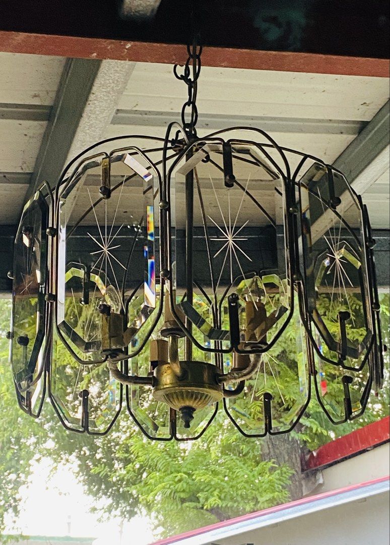 Vintage Chandelier (Category: Lighting) located in Cainta. Submitted by gonzagajuanclo (Listing ID 1466157351, Image 2). Description: Mid-century modern hanging lamp with brass frame and thick glass panels. Etched starburst designs on each glass piece catch the light beautifully. Multiple candelabra bulbs inside giving off a warm glow. Brass hardware shows nice vintage patina. Chain and ceiling mount included. Heavy fixture, needs proper installa