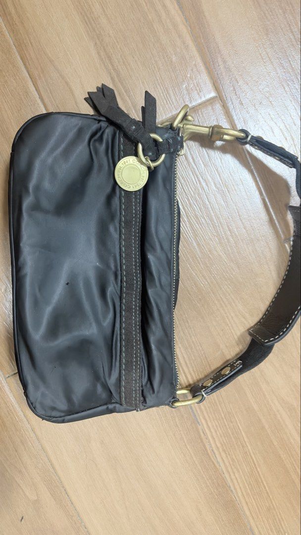Vintage Coach Black Nylon Shoulder Bag (Category: Luxury Bags & Wallets) located in Manila. Submitted by serraphimav (Listing ID 1466292078, Image 1). Description: Black nylon body with dark brown leather strap and suede trim. Brass hardware with Coach hangtag. Contrast green fabric lining inside with a zipper pocket. Small mark on the front fabric as pictured. Serial number stamped on the interior creed patch..