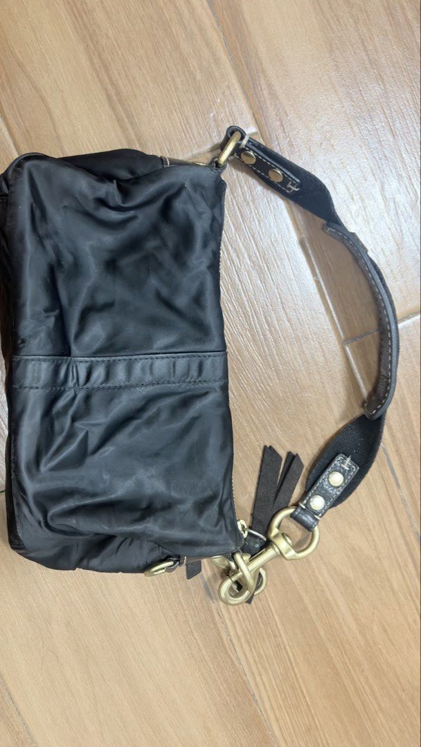Vintage Coach Black Nylon Shoulder Bag (Category: Luxury Bags & Wallets) located in Manila. Submitted by serraphimav (Listing ID 1466292078, Image 2). Description: Black nylon body with dark brown leather strap and suede trim. Brass hardware with Coach hangtag. Contrast green fabric lining inside with a zipper pocket. Small mark on the front fabric as pictured. Serial number stamped on the interior creed patch..