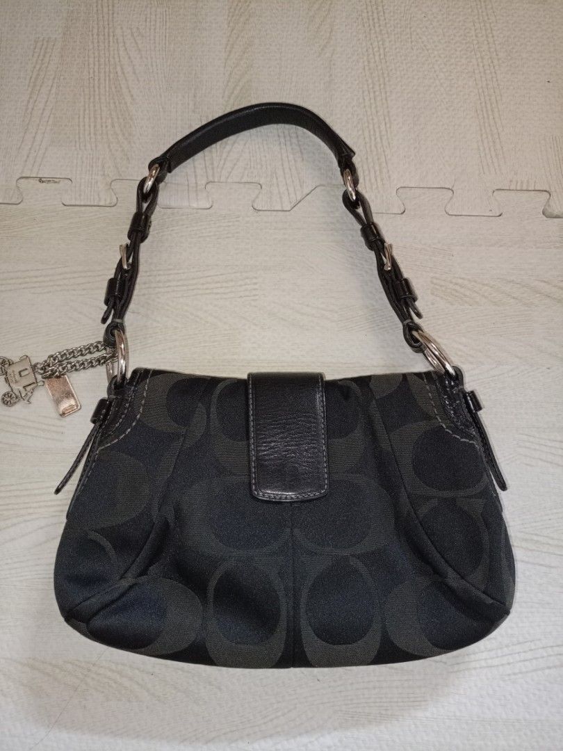 Vintage Coach Soho Rank SA (Category: Luxury Bags & Wallets) located in Quezon City. Submitted by elle_f08 (Listing ID 1466234920, Image 2). Description: - Brand: Coach - Material: Signature monogram jacquard fabric with smooth black leather trim - Color: Black and grey tones with silver-tone hardware - Closure: Front buckle closure - Strap: Adjustable leather shoulder strap with buckle detail - Inclusions: Original metal Coach carriage hangtag o