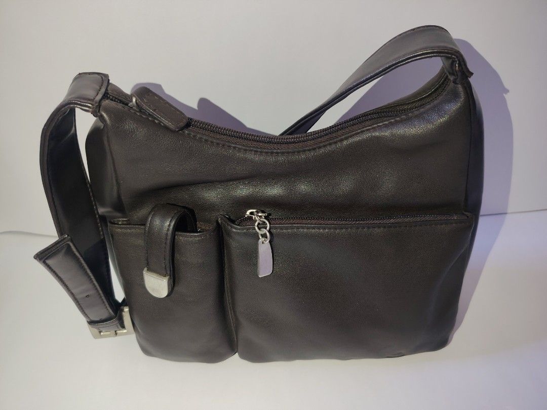 Vintage Dark Brown Leather Multi-Pocket Shoulder Bag (Category: Shoulder Bags) located in Tarlac. Submitted by your_finds (Listing ID 1466247471, Image 2). Description: Description: Sample Not sure kung genuine ang leather, but it looks like it, if not it is a high-quality leather. Condition: 8/10 / Good condition Issue: - May mga maliliit na part na medyo nag-fade na ang color, pero na repaint na kaya hindi na ito halata - Nag-fade ng kaunti ang
