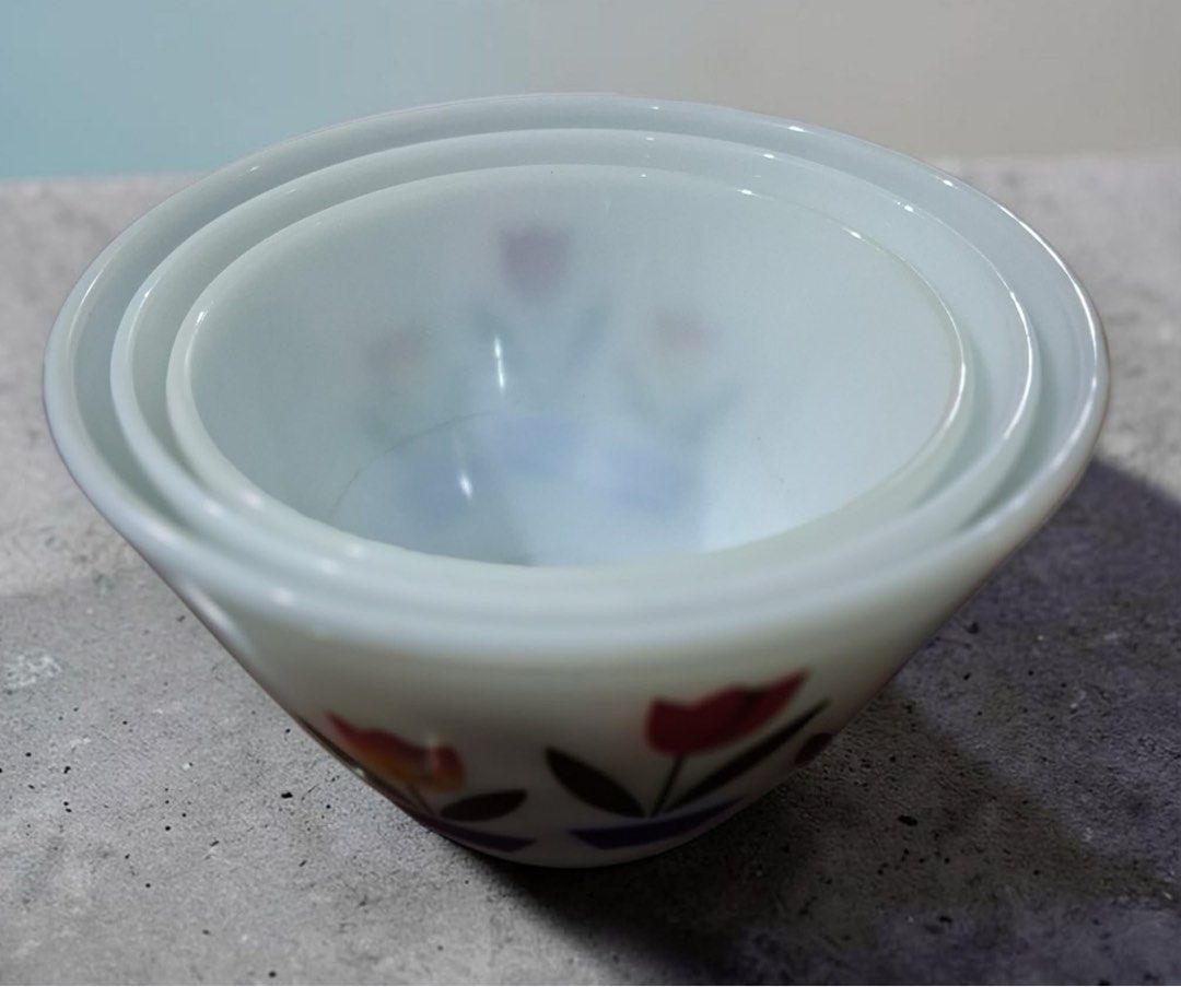 Vintage Fire King mixing bowls (Category: Dinnerware & Cutlery) located in Pasig City. Submitted by stelala19 (Listing ID 1466249659, Image 3). Description: A 3-piece set of vintage Fire King mixing bowls made of white milk glass with a colorful tulip and blue planter design. Made by Anchor Hocking of the USA in the 1950s. A very collectible piece. Sizes: small - 7in diameter, 4.5in height medium - 8in diameter, 5in height large - 9in diameter, 5