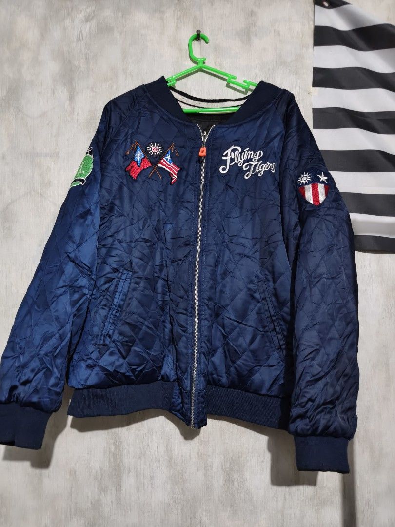 SUKAJAN Vintage Flying Tigers Regroup Mighty Eighth Reversible Bomber Jacket (Category: Coats, Jackets and Outerwear) located in Baguio. Submitted by fordaluvofthrift2600 (Listing ID 1466168343, Image 1). Description: vintage flying tigers Reversible bomber jacket with military-themed embroidery. One side features blue quilted satin with Flying Tigers patches and flags. Reverse side has black and white striped details, Mighty Eighth graphics, and
