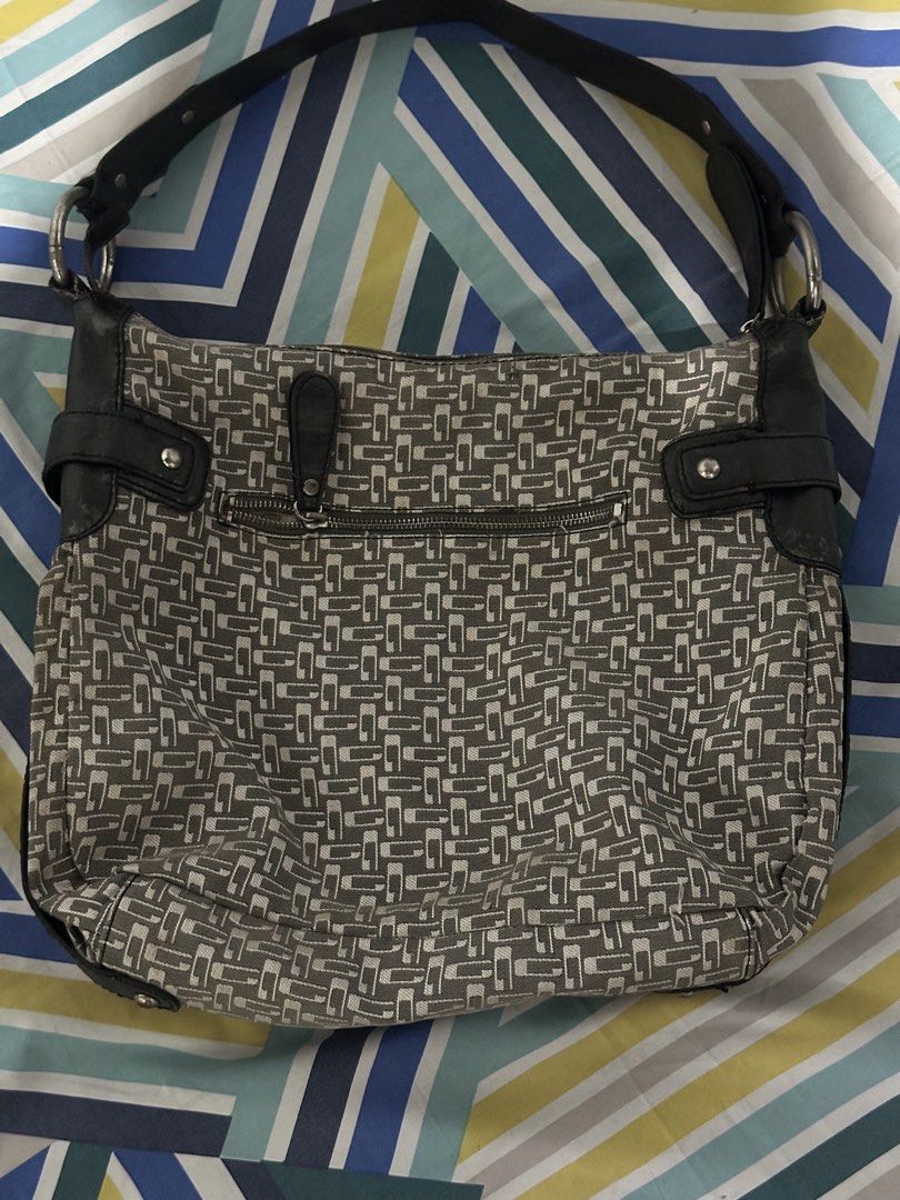 Vintage Guess Monogram Shoulder Bag (Category: Shoulder Bags) located in Bulacan. Submitted by bruella_luxxe_loved (Listing ID 1466181913, Image 2). Description: - Brand: Guess - Design: Grey and white patterned fabric with dark brown faux leather trim - Strap: Single dark brown faux leather strap - Hardware: Silver tone with large decorative front buckle and engraved Guess branding - Pockets: Exterior back zip pocket and organized interior compa