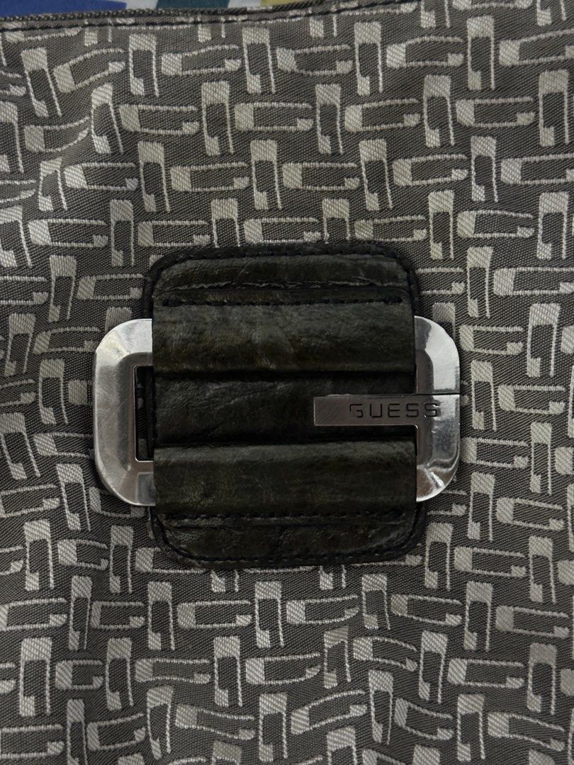 Vintage Guess Monogram Shoulder Bag (Category: Shoulder Bags) located in Bulacan. Submitted by bruella_luxxe_loved (Listing ID 1466181913, Image 3). Description: - Brand: Guess - Design: Grey and white patterned fabric with dark brown faux leather trim - Strap: Single dark brown faux leather strap - Hardware: Silver tone with large decorative front buckle and engraved Guess branding - Pockets: Exterior back zip pocket and organized interior compa
