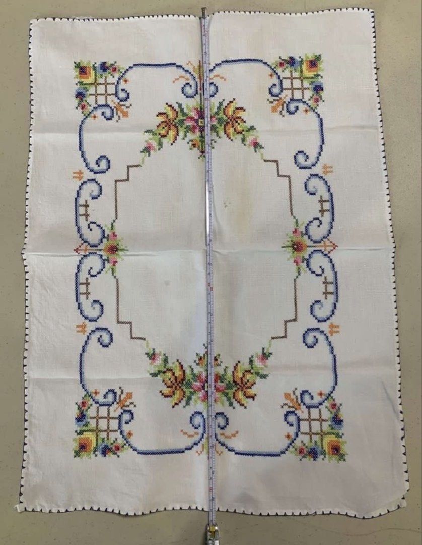 Vintage Hand-Embroidered Cross Stitch Table Runner (Category: Table Linen & Textiles) located in Quezon City. Submitted by meggoquingco (Listing ID 1466174784, Image 3). Description: - Hand-embroidered cross-stitch textile piece - Size: Approximately 39 cm x 52 cm - Design: Colorful floral motifs (yellow, pink, green) with intricate blue and brown borders - Finish: Scalloped dark blue edge all around - Flaws: A couple of faint yellowish marks nea