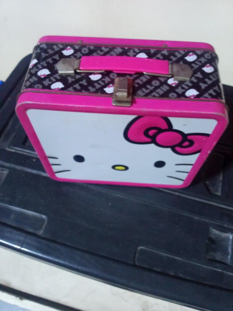 Vintage Hello Kitty Metal Lunch Box Tin Storage Container (Category: Food Organization & Storage) located in Marikina City. Submitted by norman213 (Listing ID 1466237430, Image 2). Description: - Official Kitty metal lunch box with pink trim, handle, and secure metal latch - Features classic Kitty face on the front and a stylish black pattern with mini graphics on the sides - Lid opens fully for easy access - Shows minor wear on the interior meta