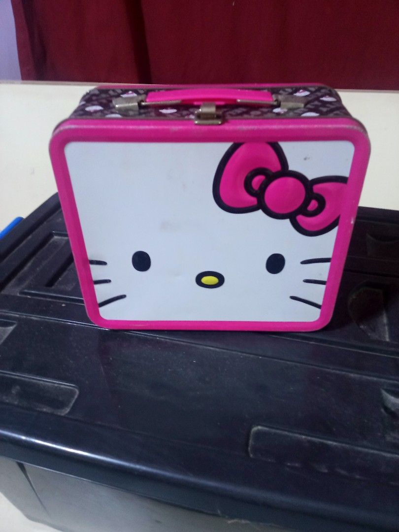 Vintage Hello Kitty Metal Lunch Box Tin Storage Container (Category: Food Organization & Storage) located in Marikina City. Submitted by norman213 (Listing ID 1466237430, Image 1). Description: - Official Kitty metal lunch box with pink trim, handle, and secure metal latch - Features classic Kitty face on the front and a stylish black pattern with mini graphics on the sides - Lid opens fully for easy access - Shows minor wear on the interior meta