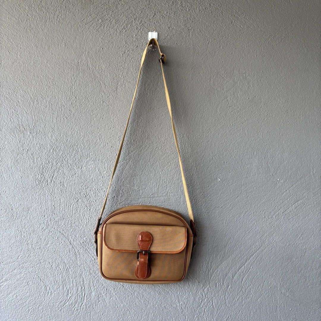 Vintage lancel paris bag (Category: Sling Bags) located in San Fernando. Submitted by diff.thr1ft (Listing ID 1466169198, Image 1). Description: - Authentic vintage Lancel Paris sling bag - Classic tan/beige canvas body with brown leather trim - Front flap pocket with secure buckle closure - Convenient zippered main compartment and back zip pocket - Durable, adjustable canvas shoulder strap - Timeless design perfect for everyday casual wear Issue