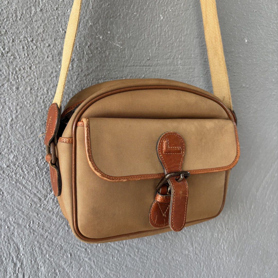 Vintage lancel paris bag (Category: Sling Bags) located in San Fernando. Submitted by diff.thr1ft (Listing ID 1466169198, Image 2). Description: - Authentic vintage Lancel Paris sling bag - Classic tan/beige canvas body with brown leather trim - Front flap pocket with secure buckle closure - Convenient zippered main compartment and back zip pocket - Durable, adjustable canvas shoulder strap - Timeless design perfect for everyday casual wear Issue