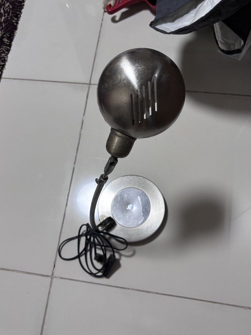 Vintage metallic adjustable desk lamp with round base (Category: Lighting) located in Manila. Submitted by silentdeer.537e56 (Listing ID 1466260456, Image 2). Description: - Silver-toned metal desk lamp with a stylish spherical shade and ventilation slots - Fully adjustable arm and sturdy, round weighted base for stability - Features a standard bulb socket and comes with a working LED bulb - Convenient black power cord equipped with an easy-to-us
