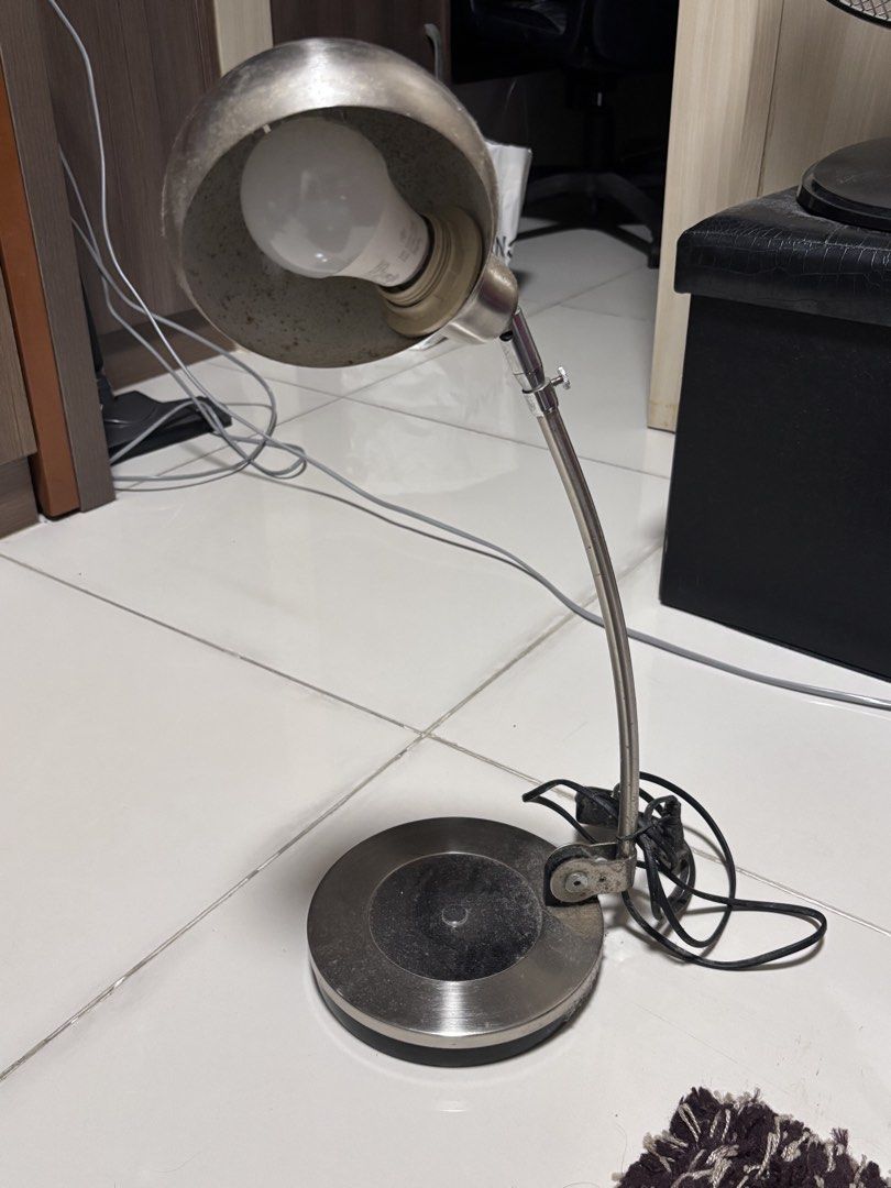 Vintage metallic adjustable desk lamp with round base (Category: Lighting) located in Manila. Submitted by silentdeer.537e56 (Listing ID 1466260456, Image 1). Description: - Silver-toned metal desk lamp with a stylish spherical shade and ventilation slots - Fully adjustable arm and sturdy, round weighted base for stability - Features a standard bulb socket and comes with a working LED bulb - Convenient black power cord equipped with an easy-to-us