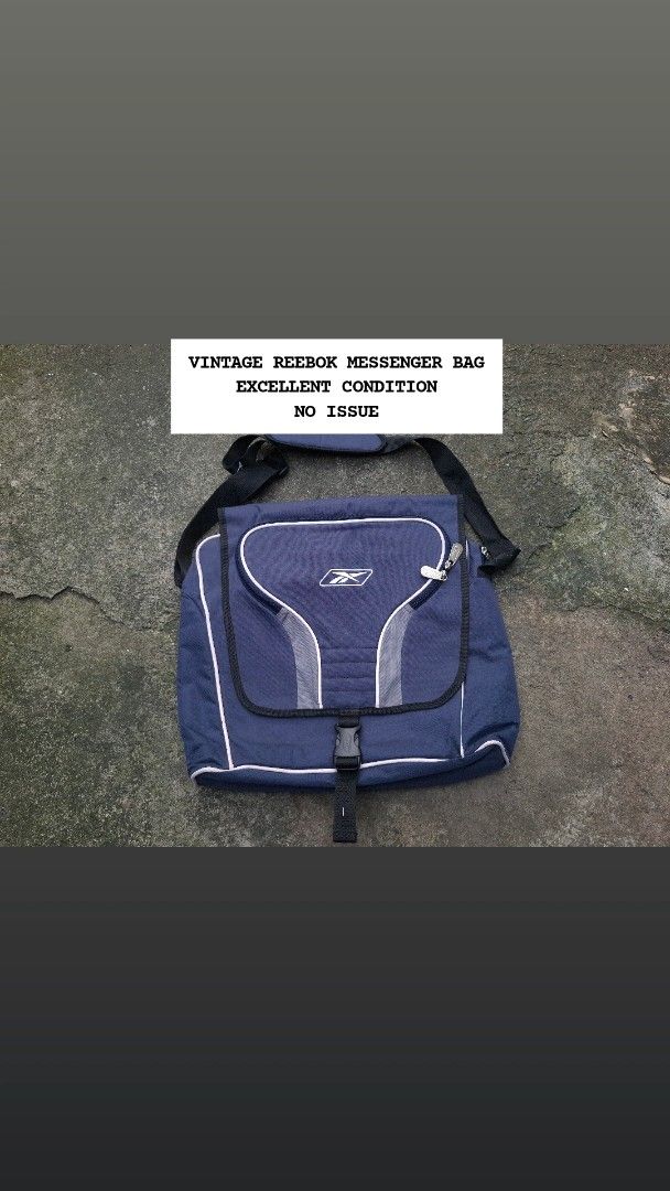 Vintage Reebok Messenger Bag Blue (Category: Sling Bags) located in Manila. Submitted by bonaobrag55538 (Listing ID 1466200538, Image 1). Description: Blue Reebok messenger bag with grey piping details and white embroidered logo. Front flap pocket with dual zippers, main compartment with inner dividers and Velcro strap. Adjustable shoulder strap featuring a padded section for comfort. Sturdy plastic buckle closure on the front flap..