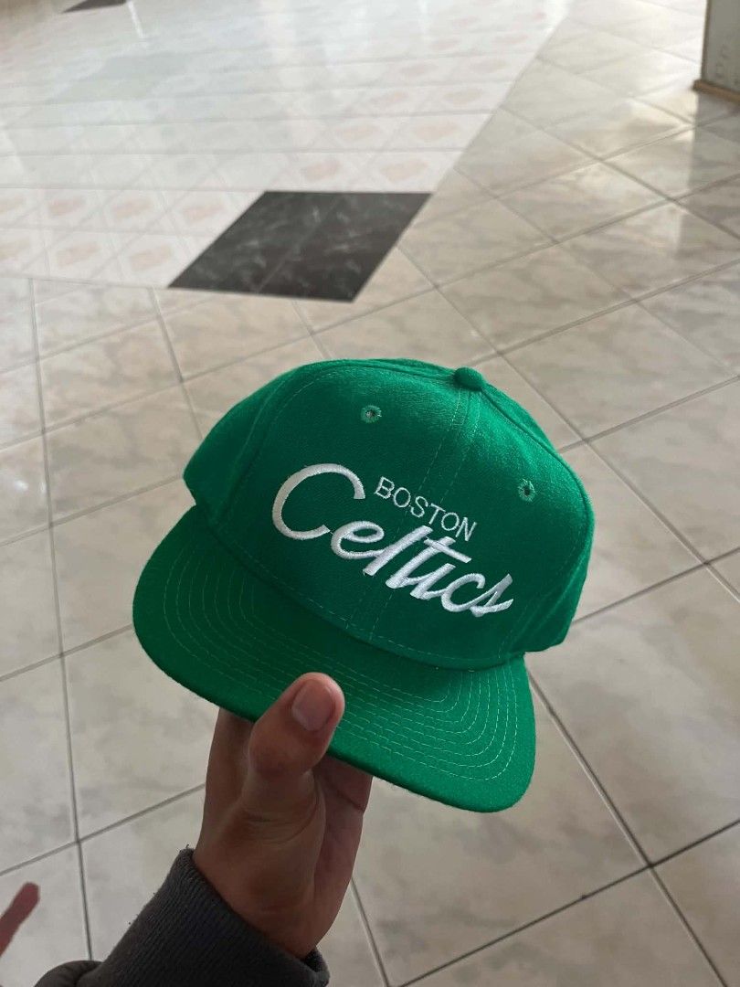 Vintage Sline Boston Celtics (Category: Caps & Hats) located in Dagupan City. Submitted by supremacy_deluxe (Listing ID 1466181466, Image 1). Description: - Authentic vintage green Boston Celtics snapback cap - Features striking white embroidered script logo on the front - Official NBA licensed product tag attached inside - Adjustable plastic snapback closure for a customized fit - Clean white inner sweatband with only minor signs of handling - P