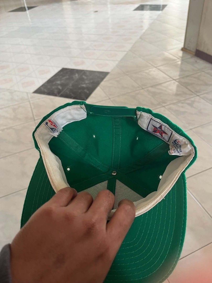 Vintage Sline Boston Celtics (Category: Caps & Hats) located in Dagupan City. Submitted by supremacy_deluxe (Listing ID 1466181466, Image 2). Description: - Authentic vintage green Boston Celtics snapback cap - Features striking white embroidered script logo on the front - Official NBA licensed product tag attached inside - Adjustable plastic snapback closure for a customized fit - Clean white inner sweatband with only minor signs of handling - P