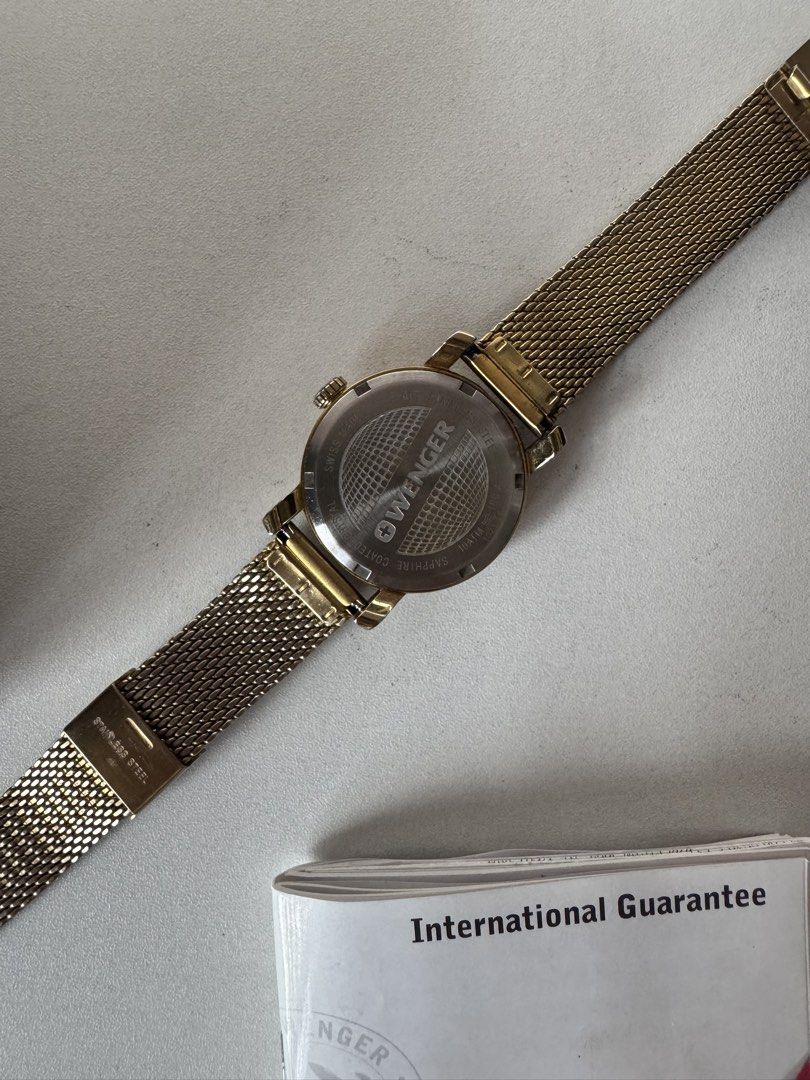 Wenger Gold-Tone Mesh Watch with Box (Category: Women's Watches) located in Davao. Submitted by rctongco7762375 (Listing ID 1466178782, Image 2). Description: • Model: Urban Classic Lady (01.1021.118) • Movement: Swiss Quartz (Battery-powered) • Case Size: 34mm • Inclusions: Comes with the original instructions booklet, service center guide, and the original stamped purchase paper. ⚠️ Honest Condition Note: This is a pre-loved vintage piece from 
