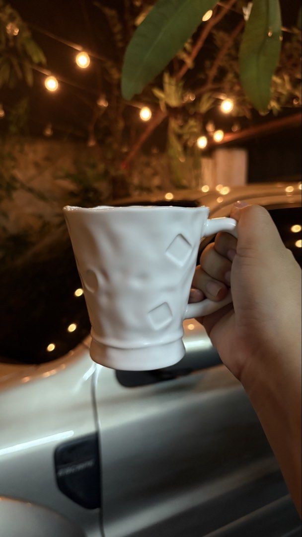 White Ceramic Mug with Textured Geometric Pattern (Category: Coffee & Tea Tableware) located in Manila. Submitted by mug.aras (Listing ID 1466313182, Image 1). Description: White ceramic mug with a unique textured geometric surface and flare base. Features a comfortable handle and a sturdy build. Perfect for your daily coffee or tea..