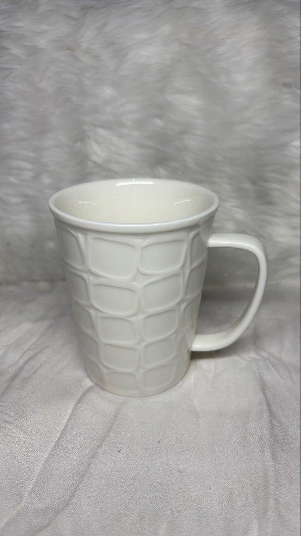White Ceramic Mug with Textured Geometric Pattern (Category: Coffee & Tea Tableware) located in Manila. Submitted by mug.aras (Listing ID 1466314011, Image 1). Description: White ceramic coffee mug with a stylish raised geometric grid pattern and glossy finish. Holds a great size for your morning coffee or tea. Clean, no chips or cracks, and ready to use!.