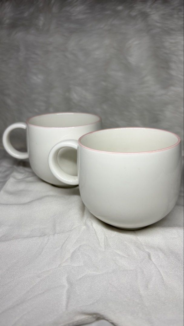 White Ceramic Mugs with Pink Rim (Category: Coffee & Tea Tableware) located in Manila. Submitted by mug.aras (Listing ID 1466314608, Image 1). Description: White ceramic mugs with a delicate pink rim stripe. Glossy finish, comfortable handle, standard size. Clean, no chips. Perfect for your daily coffee or tea! (₱150 each - 2 available).