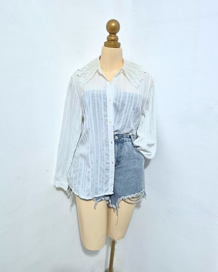 White Lace Collar Striped Blouse | Long Sleeve Button Down | M-L (Category: Longsleeves) located in Cabanatuan. Submitted by _erboutique (Listing ID 1466329801, Image 3). Description: • White semi-sheer vertical striped shirt • Delicate scalloped lace collar detail • Button front, lightweight textured fabric • Relaxed fit | Size M–L • Shoulder 18" | Bust 44" | Length 23" • Feminine casual office wear • Excellent preowned condition.