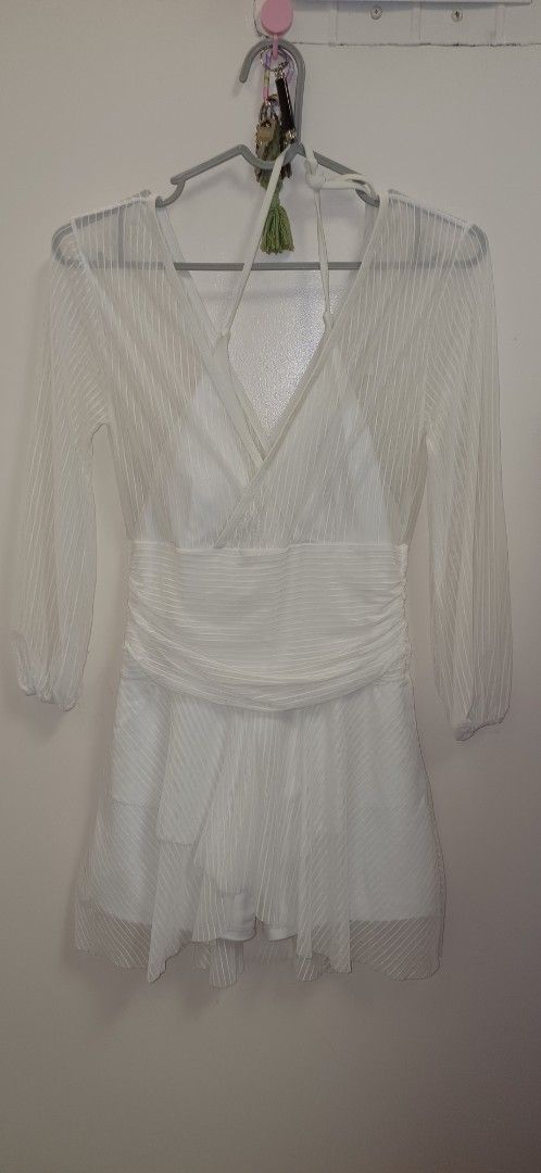 Conservative swimwear in mesh white (Category: Bikinis & Swimsuits) located in Pasay City. Submitted by pepper1997 (Listing ID 1466306763, Image 2). Description: - Color: White - Style: Mini dress with diagonal striped texture and inner lining - Features: Long sheer sleeves, crossed V-neckline with halter straps, and wide draped waistband for a fitted silhouette - Skirt: Flowy layered skirt with handkerchief hem details - Occasion: Great for part