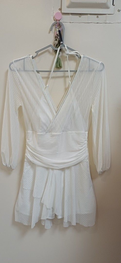 Conservative swimwear in mesh white (Category: Bikinis & Swimsuits) located in Pasay City. Submitted by pepper1997 (Listing ID 1466306763, Image 1). Description: - Color: White - Style: Mini dress with diagonal striped texture and inner lining - Features: Long sheer sleeves, crossed V-neckline with halter straps, and wide draped waistband for a fitted silhouette - Skirt: Flowy layered skirt with handkerchief hem details - Occasion: Great for part