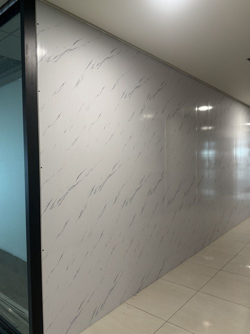 White Marble Look PVC Wall Panels (Category: Wall Decor) located in Manila. Submitted by marquezpa52205 (Listing ID 1466213084, Image 1). Description: - Item: White wall panels with grey marble pattern - Finish: Glossy, clean modern aesthetic - Condition: Used, selling as-is after office renovation - Layout: Multiple vertical panels previously installed side by side - Perfect for upgrading office hallways or modernizing interiors.