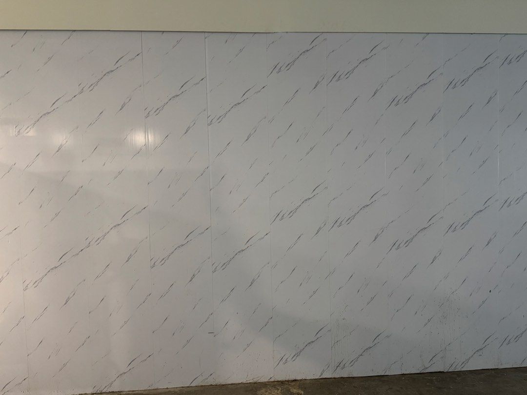 White Marble Look PVC Wall Panels (Category: Wall Decor) located in Manila. Submitted by marquezpa52205 (Listing ID 1466213084, Image 2). Description: - Item: White wall panels with grey marble pattern - Finish: Glossy, clean modern aesthetic - Condition: Used, selling as-is after office renovation - Layout: Multiple vertical panels previously installed side by side - Perfect for upgrading office hallways or modernizing interiors.