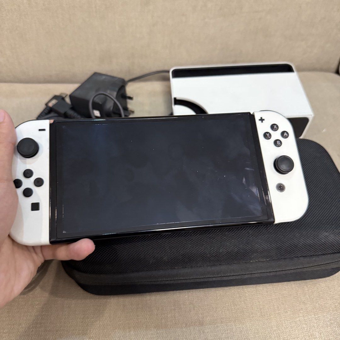 White Nintendo Switch Oled for Sale (Category: Nintendo) located in Pasig City. Submitted by mikollol (Listing ID 1466163818, Image 2). Description: White Nintendo Switch OLED WITH FREEBIES - Like new condition and no issues - 10,000 php fix price - Lost Original Box 📍Manila (weekdays) 📍 Pasig (weekends) Inclusions: ✅ White Nintendo Switch w/ tempered glass ✅ Original Box ✅ Charger ✅ Joy-Con (L&R) ✅ Joy-Con Straps ✅ Joy-Con Grip ✅ HDMI Cable ✅ 
