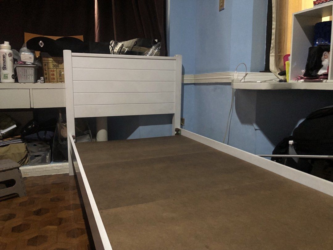 White Single Bed Frame with Slatted Headboard (Category: Bed Frames & Mattresses) located in Taguig. Submitted by castaneda.rymnd (Listing ID 1466218309, Image 3). Description: - Color & Material: Solid white wood - Design: Modern horizontal slats on headboard and footboard - Size: Standard single - Includes: Sturdy base support boards - Features: Clean look, easy to assemble and dismantle for moving.