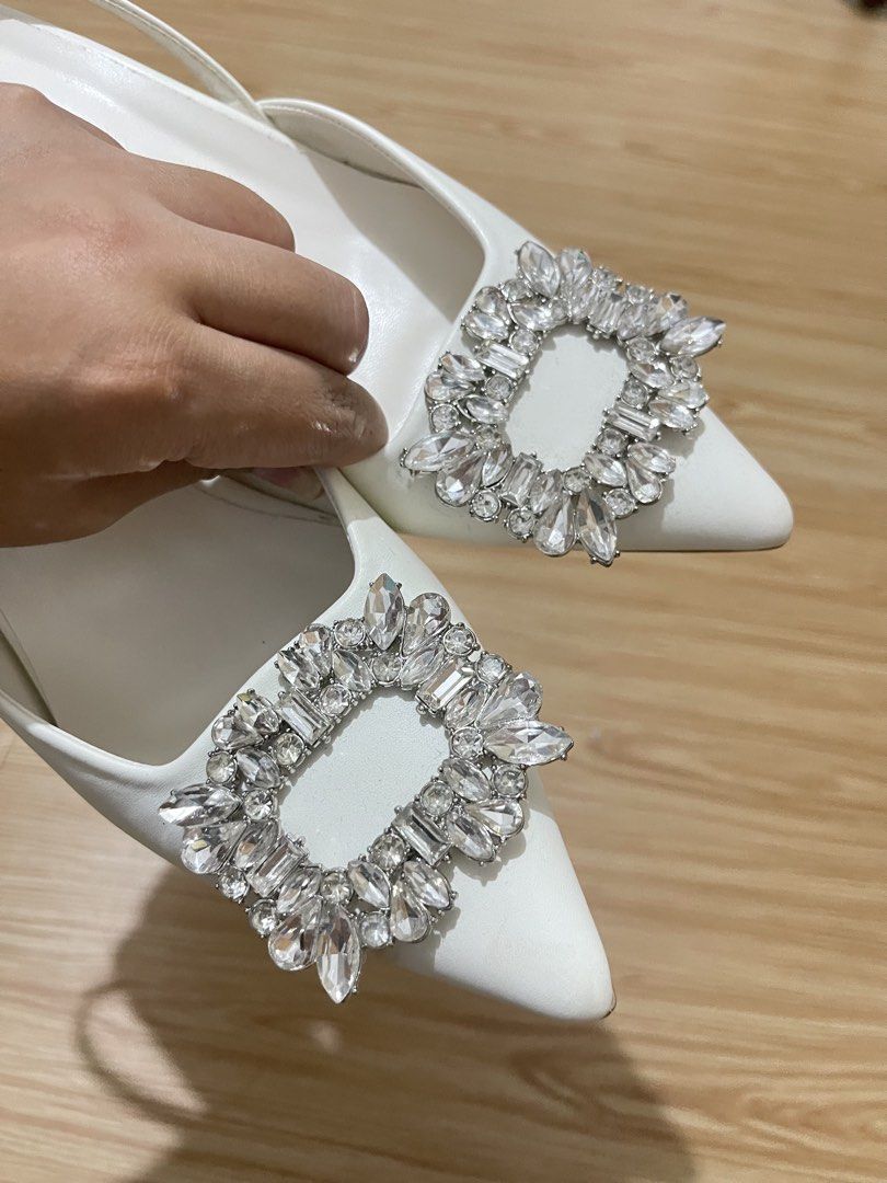 White slingback heels with crystal buckle size 36 (Category: Heels) located in Manila. Submitted by dyvmx949t543465 (Listing ID 1466245893, Image 3). Description: - Color: White - Style: Slingback heels with pointed toe and low kitten heel - Detail: Large rhinestone buckle on the front - Size: 36 (stamped on sole) - Condition: Worn once, minor wear on soles.
