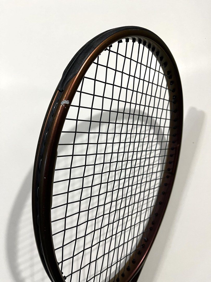Wilson Pro Staff V14 Tennis Racket (Category: Racket and Ball Sports) located in Cebu City. Submitted by adriano.adriano (Listing ID 1466220466, Image 3). Description: - original Wilson Pro Staff V14 tennis racket - Color: Metallic bronze finish - Grip Size: 3 4/8 - Setup: Strung and ready for play with a premium leather grip installed - Condition: Good structural condition with minor scuffs and paint chips on the top hoop (just cosmetic wear fro