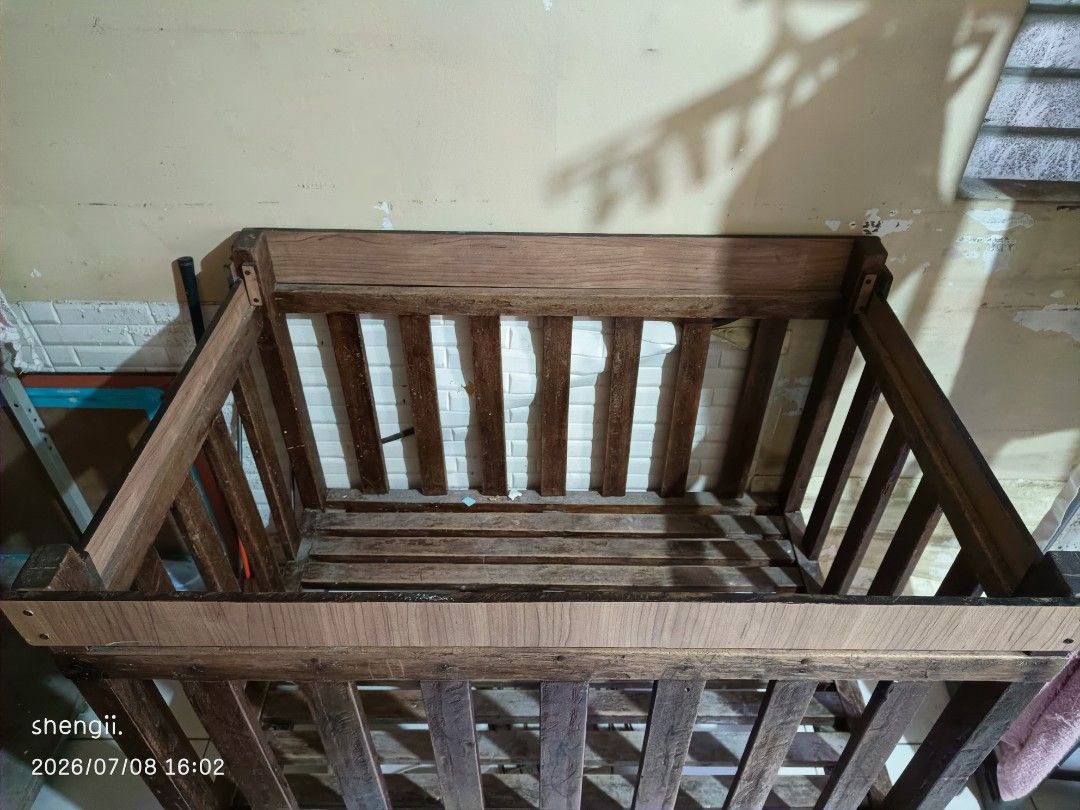 Wooden Baby Crib (Category: Cots & Cribs) located in Taguig. Submitted by shengii1234 (Listing ID 1466187242, Image 1). Description: WOODEN CRIB. Made of hard wood di ko na matandaan ang pangalan ng wood na ginamit but this one is customized. This has been with us for 16 years. Ganun sya katibay. Konting linis and varnish lang and like new na ulit sya kasi magandang kahoy ginamit. RFS: declutter kasi sayang sa space at malalaki na ang mga anak. W