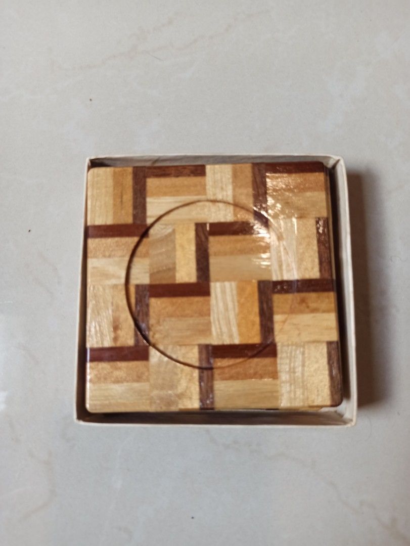Wooden hand made Coaster Set with Storage Box - Great looking coaster design (Category: Dinnerware & Cutlery) located in Caloocan City. Submitted by rtarellano (Listing ID 1466172000, Image 1). Description: - Set of 5 wooden square coasters (3.5 inches across) - Features an eye-catching geometric parquet pattern and recessed circle center - Elegant glossy finish suitable for hot and cold drinks - Comes with original fitted cardboard storage box f