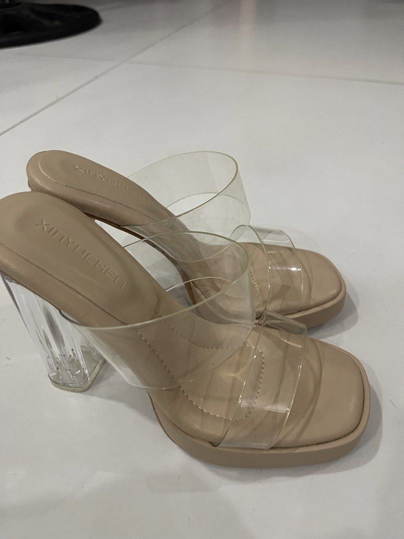 Xinyulichen Clear Strap Platform Heels Nude (Category: Heels) located in Manila. Submitted by mariel1124 (Listing ID 1466245842, Image 3). Description: - Color/Style: Nude platform heels with modern square toe - Straps: Clear transparent double straps across the top - Heel: Tall, transparent block heel for a trendy look - Fit: Easy slip-on style - Best For: Nights out, parties, and special events.