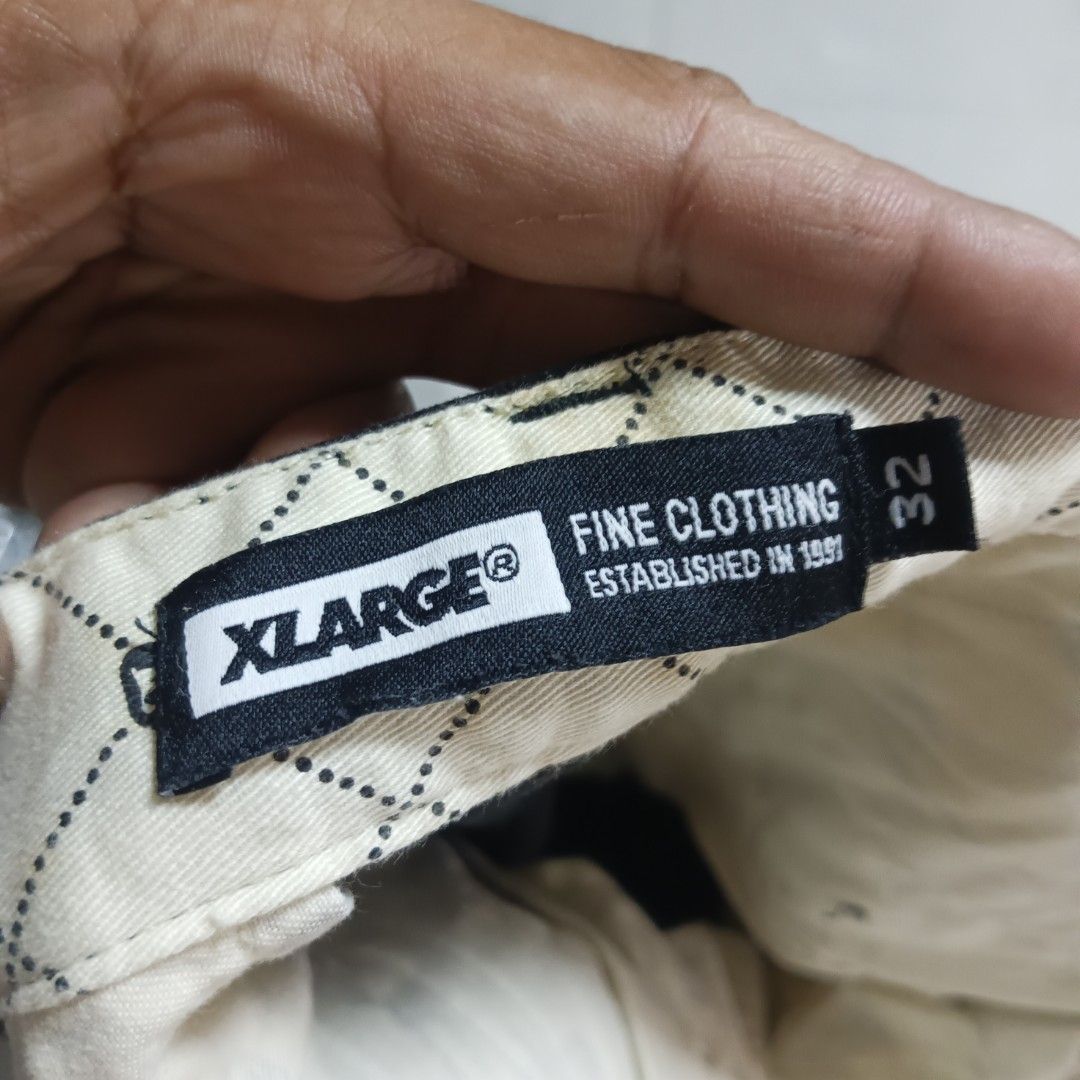 Xlarge Black Workwear Pants Size 32 (Category: Trousers) located in Alaminos. Submitted by andreid12 (Listing ID 1466287561, Image 2). Description: - Brand: Xlarge - Size: 32 (Waistband tag) - Material: Sturdy cotton twill with cream patterned inner lining - Fit: Straight leg cut - Design: Big white Xlarge logo printed on back right leg, woven brand label on back pocket - Closure: Standard button and zip fly.