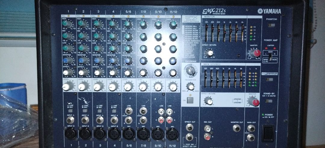 Yamaha EMX212S Powered Mixer (Category: Soundbars, Speakers & Amplifiers) located in Quezon City. Submitted by mdmedz (Listing ID 1466322352, Image 1). Description: Yamaha EMX212S 12-channel powered mixer in black casing. Features built-in amplification, comprehensive EQ controls, faders, and side carrying handles. Standard 230V power input. Tested and powers up properly. No isssue..
