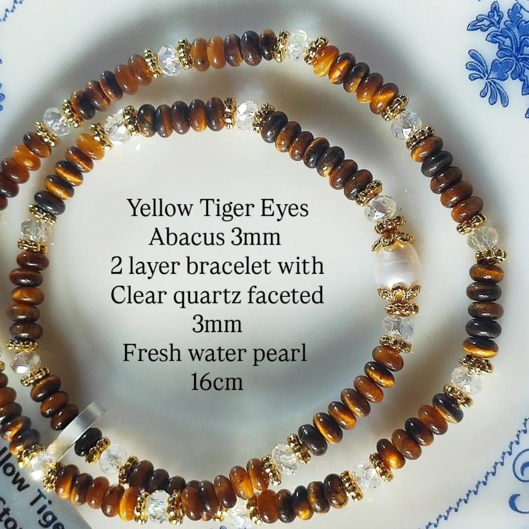 Yellow Tiger Eyes Abacus 3mm 2 Layer Bracelet (Category: Bracelets) located in Kinoguitan. Submitted by artemiscrystal (Listing ID 1466280702, Image 1). Description: - Two-layer handmade gemstone bracelet - 3mm yellow tiger eye abacus and faceted clear quartz stones - Elegant freshwater pearl accent - Gold-tone spacer beads - wrist size: 16cm - Made with natural stones.