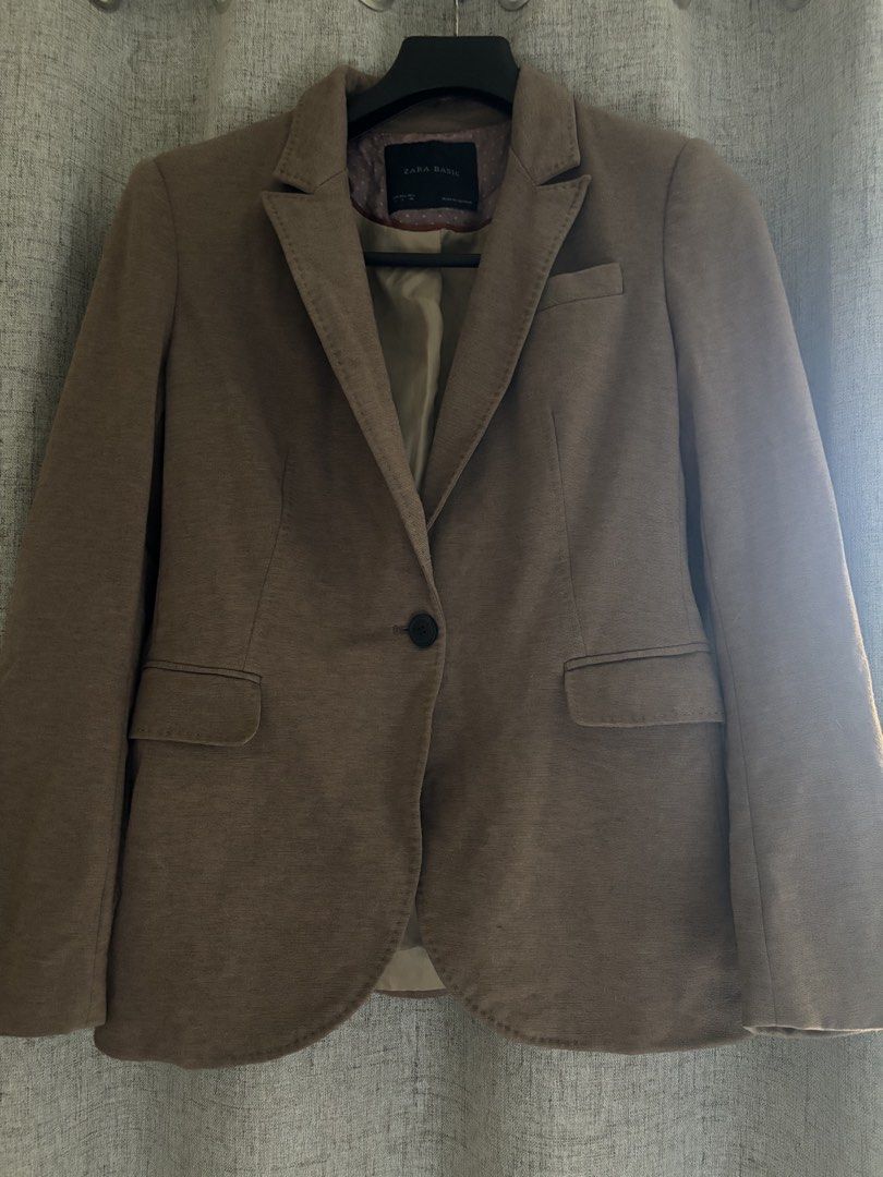Zara Basic Brown Blazer Size L (Category: Coats, Jackets and Outerwear) located in Manila. Submitted by erin_closet (Listing ID 1466221333, Image 1). Description: - Brand: Zara Basic - Size: L - Color: Brown - Closure: Single front button - Pockets: Two front flap pockets - Details: Structured shoulders, tailored back fit, pink polka dot inner collar, tan satin lining - Origin: Made in Vietnam - Fits Large.